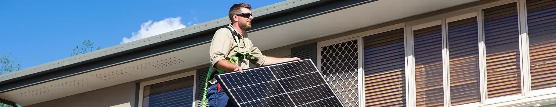 Fallon Solutions solar technician installing solar panels on a home rooftop.