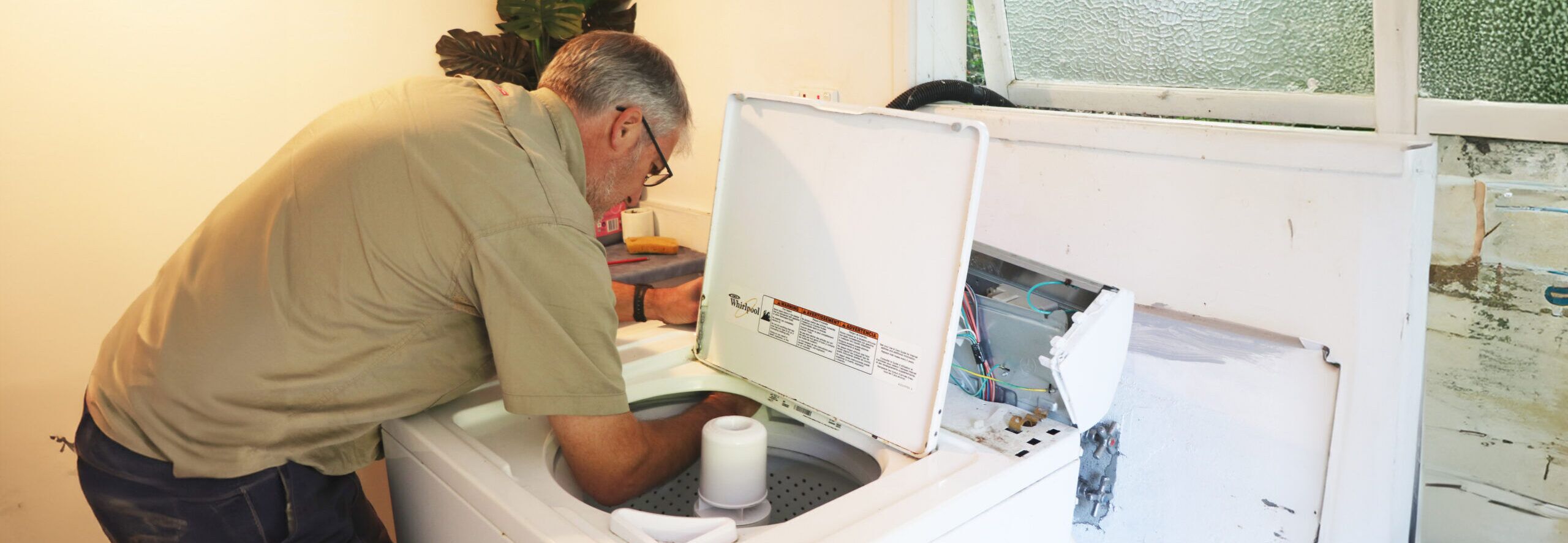 Fallon Solutions appliance repair technician diagnosing an issue with a clothes dryer.